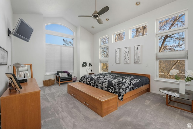 carpeted bedroom featuring lofted ceiling and ceiling fan