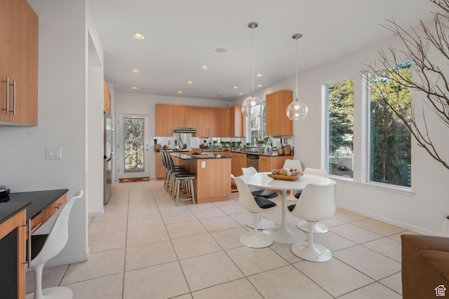 dining space with light tile patterned floors and a healthy amount of sunlight