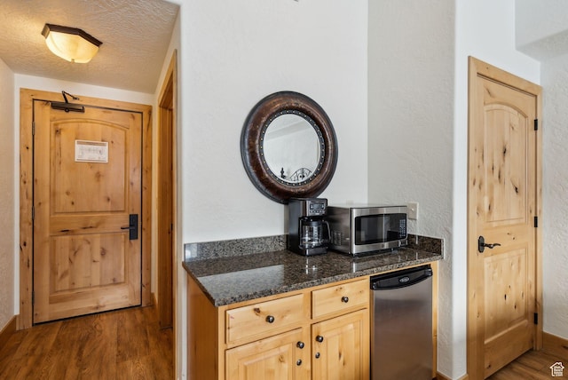 2653 Canyons Resort Dr Unit 223, Park City, UT 84098 - kitchen featuring a textured ceiling, dark hardwood / wood-style flooring, dark stone counters, fridge, and light brown cabinets