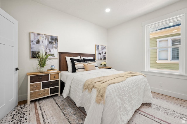 bedroom featuring recessed lighting, light wood-type flooring, and baseboards