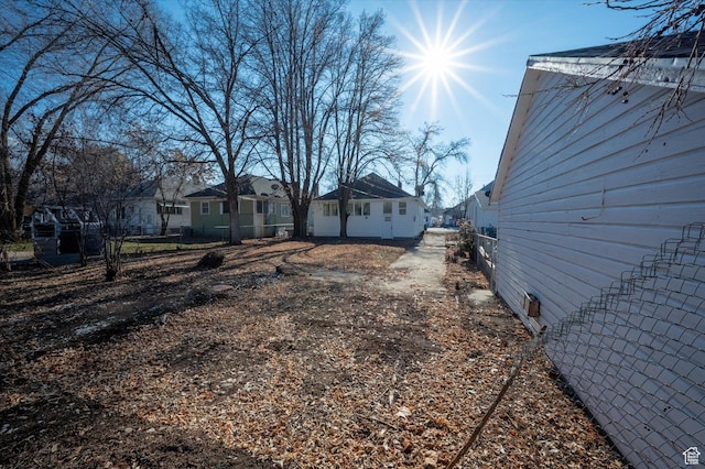 view of yard featuring a residential view and fence