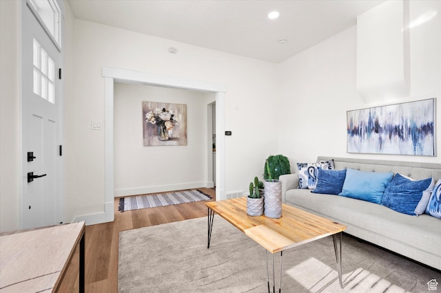living room featuring recessed lighting, wood finished floors, visible vents, and baseboards