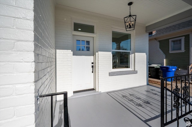 doorway to property with brick siding