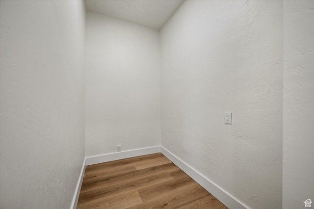 interior space with baseboards and wood finished floors