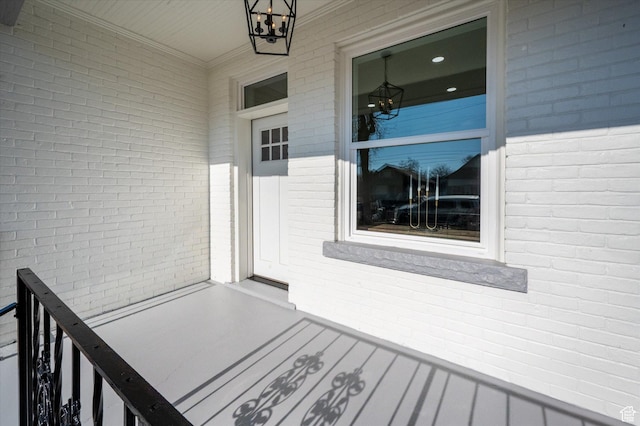 doorway to property featuring brick siding