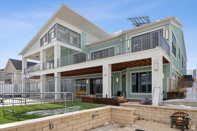 13599 S White Pony Rd W, Herriman, UT 84096 - rear view of house featuring an outdoor fire pit, a balcony, and a patio