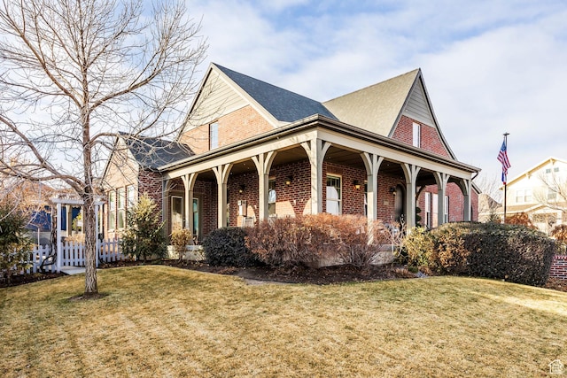 view of front of home featuring a front lawn and brick siding