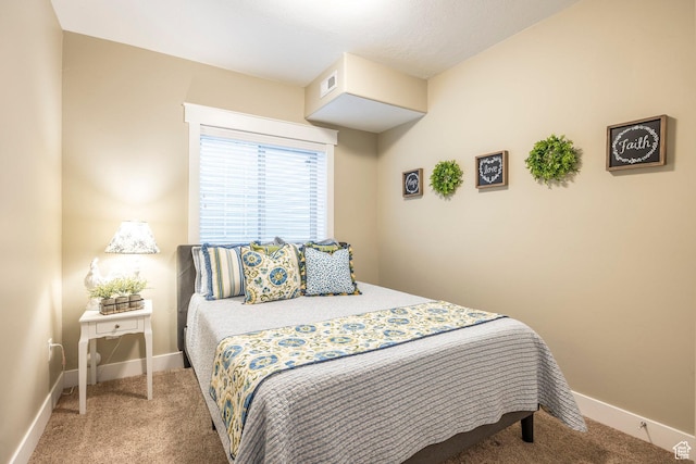 carpeted bedroom featuring visible vents and baseboards