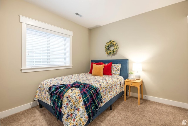 bedroom featuring visible vents, baseboards, and carpet flooring