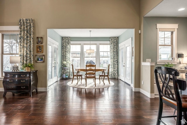 dining space featuring baseboards and dark wood-style flooring