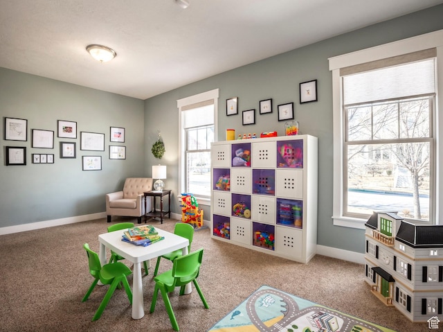 rec room with baseboards and carpet floors