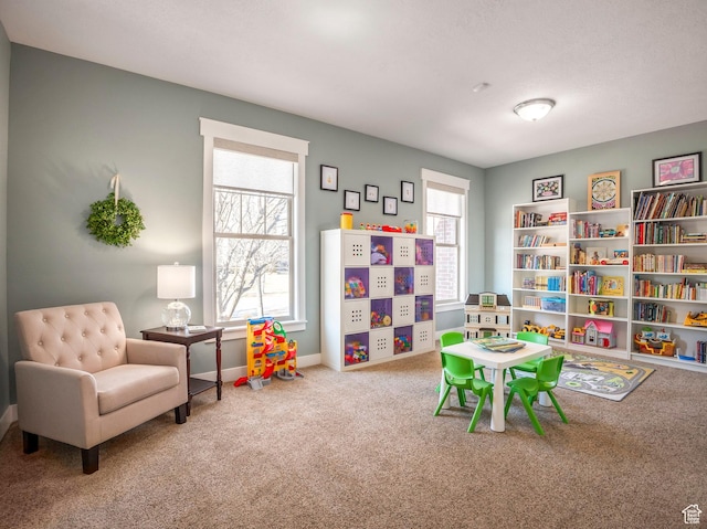 rec room with a wealth of natural light, baseboards, and carpet floors