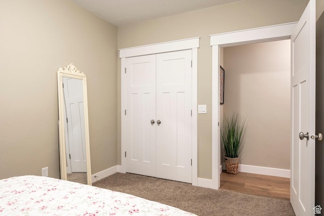 unfurnished bedroom with baseboards, a closet, and carpet floors