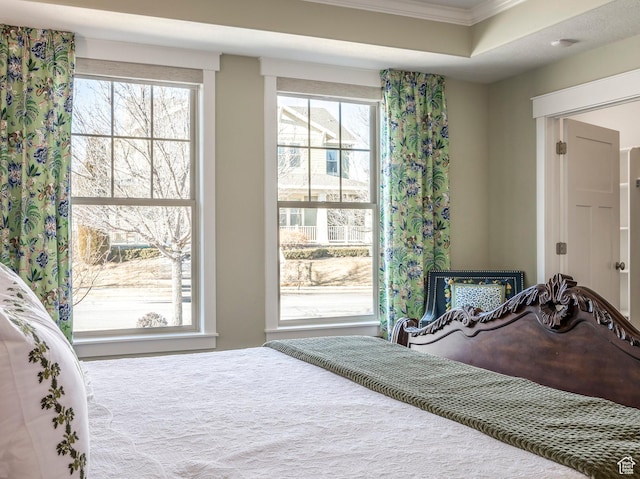 bedroom with multiple windows and ornamental molding