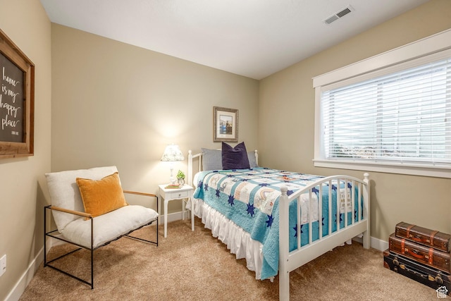 carpeted bedroom with baseboards and visible vents