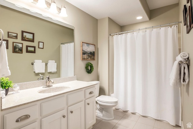 full bath with vanity, toilet, and tile patterned flooring