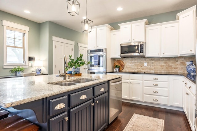 kitchen with white cabinetry, appliances with stainless steel finishes, and a sink