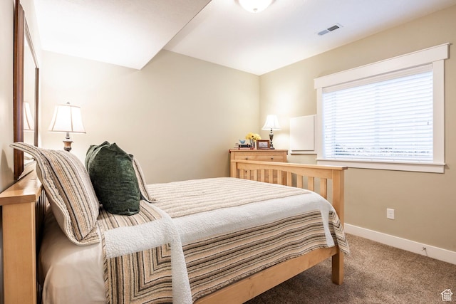 bedroom with carpet, visible vents, and baseboards
