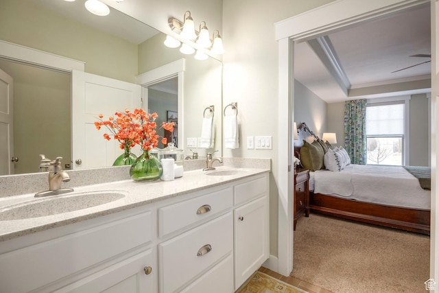 ensuite bathroom featuring double vanity, ornamental molding, ensuite bathroom, and a sink