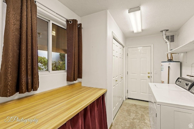 1050 W Red Hills Pkwy Unit 2, Washington, UT 84780 - clothes washing area with a textured ceiling, light colored carpet, washing machine and clothes dryer, and gas water heater