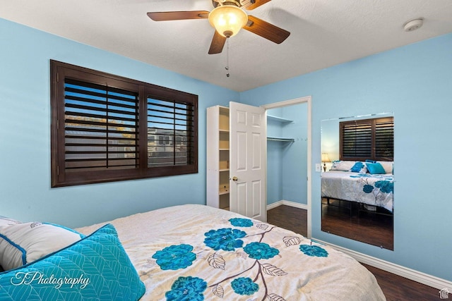 1050 W Red Hills Pkwy Unit 2, Washington, UT 84780 - bedroom featuring dark hardwood / wood-style flooring, a walk in closet, ceiling fan, and a closet