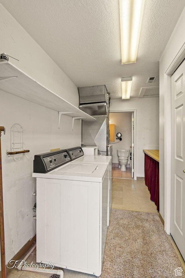 1050 W Red Hills Pkwy Unit 2, Washington, UT 84780 - clothes washing area featuring a textured ceiling and washer and clothes dryer