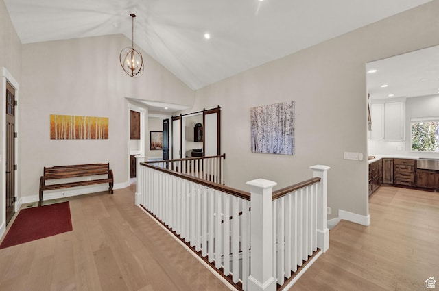 10694 E Cottonwood Ln Unit 539, Heber City, UT 84032 - hall featuring an upstairs landing, a notable chandelier, light wood-type flooring, and baseboards
