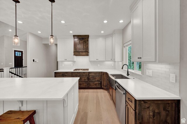 10694 E Cottonwood Ln Unit 539, Heber City, UT 84032 - kitchen with a sink, stainless steel appliances, light countertops, white cabinets, and light wood-type flooring