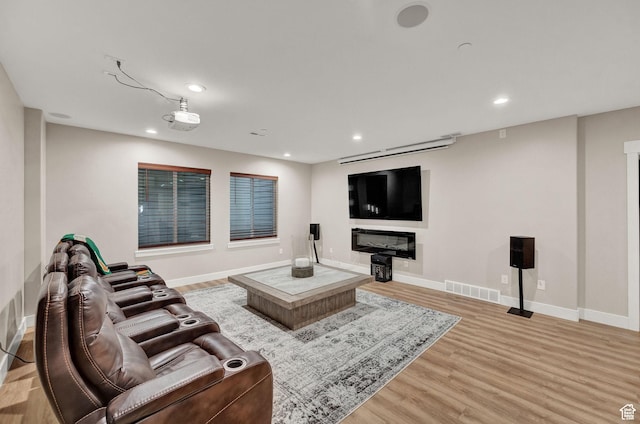 10694 E Cottonwood Ln Unit 539, Heber City, UT 84032 - living area with light wood-type flooring, visible vents, a glass covered fireplace, recessed lighting, and baseboards