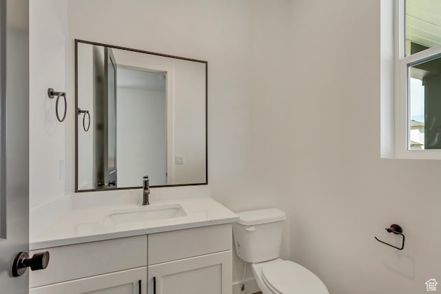 half bath with vanity and toilet
