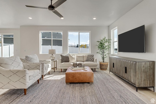 living area with a ceiling fan and recessed lighting