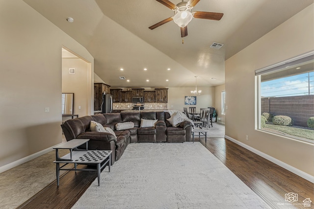 1987 S 2940 E, St George, UT 84790 - living room featuring vaulted ceiling, ceiling fan with notable chandelier, and wood-type flooring