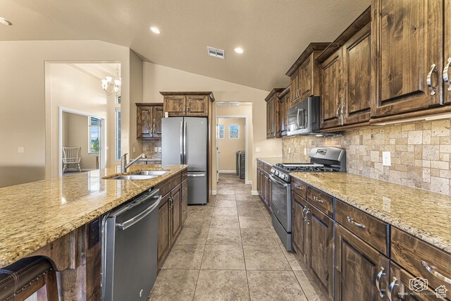 1987 S 2940 E, St George, UT 84790 - kitchen featuring stainless steel appliances, light stone countertops, sink, an inviting chandelier, and backsplash