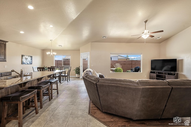 1987 S 2940 E, St George, UT 84790 - living room featuring sink, a textured ceiling, ceiling fan with notable chandelier, and light tile patterned floors