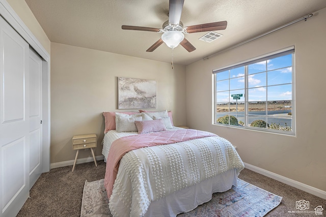 1987 S 2940 E, St George, UT 84790 - bedroom featuring ceiling fan, a closet, and dark colored carpet