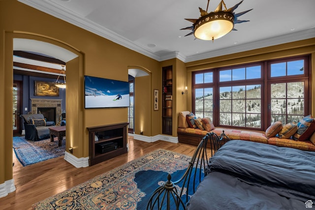 17 White Pine Canyon Rd, Park City, UT 84060 - bedroom with arched walkways, wood finished floors, a fireplace, and crown molding