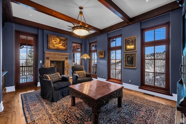 17 White Pine Canyon Rd, Park City, UT 84060 - sitting room with baseboards, a premium fireplace, beam ceiling, wood finished floors, and a ceiling fan