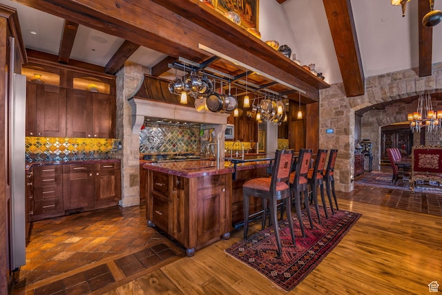 17 White Pine Canyon Rd, Park City, UT 84060 - kitchen featuring arched walkways, a notable chandelier, backsplash, and dark wood-style flooring
