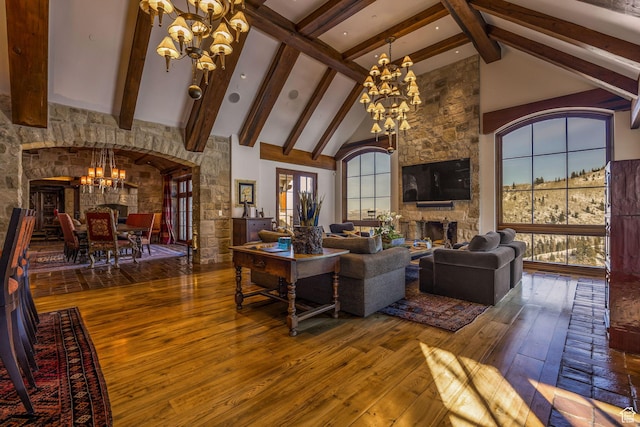 17 White Pine Canyon Rd, Park City, UT 84060 - living room with high vaulted ceiling, a stone fireplace, hardwood / wood-style flooring, beamed ceiling, and a chandelier