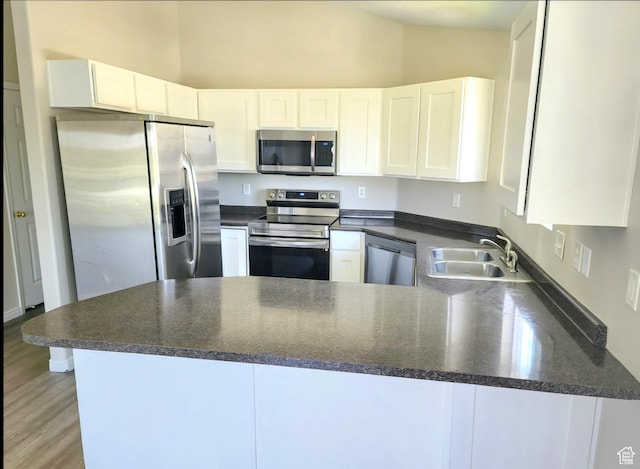 1617 W Treille Ct Unit I12, West Valley City, UT 84119 - kitchen with kitchen peninsula, stainless steel appliances, and white cabinetry