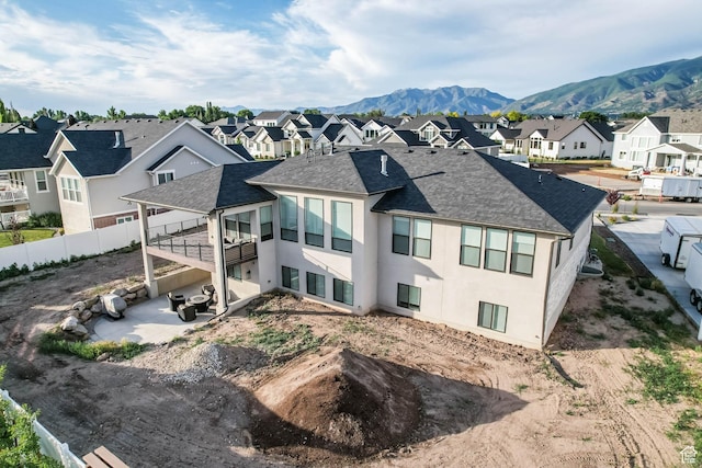 51 N Gray Fox Cir, Kaysville, UT 84037 - back of property featuring a residential view, a patio, a shingled roof, a mountain view, and stucco siding