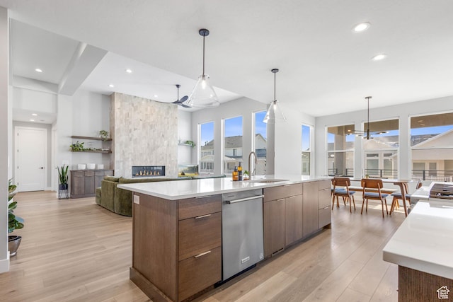 51 N Gray Fox Cir, Kaysville, UT 84037 - kitchen featuring decorative light fixtures, a fireplace, a large island with sink, stainless steel dishwasher, and a notable chandelier