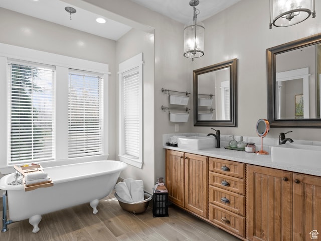 277 W Canyon Crest Rd, Alpine, UT 84004 - bathroom featuring a freestanding tub, double vanity, a sink, and wood finished floors