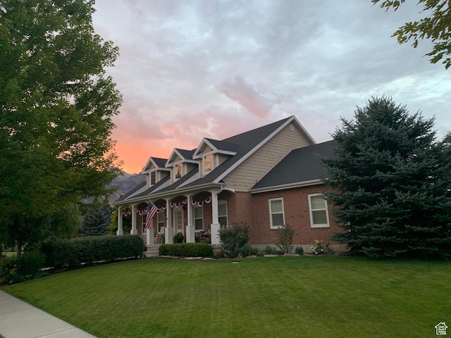 277 W Canyon Crest Rd, Alpine, UT 84004 - view of front facade featuring brick siding, a porch, and a lawn