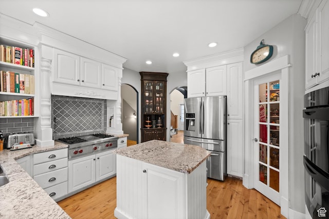 277 W Canyon Crest Rd, Alpine, UT 84004 - kitchen with recessed lighting, white cabinets, decorative backsplash, stainless steel appliances, and arched walkways