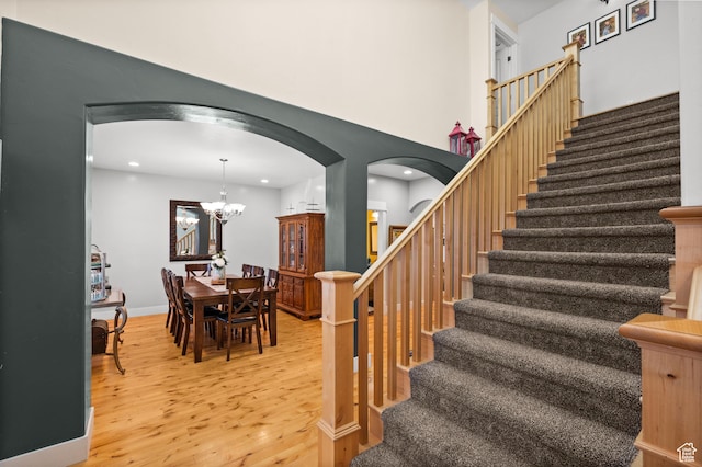 277 W Canyon Crest Rd, Alpine, UT 84004 - staircase with recessed lighting, arched walkways, an inviting chandelier, and wood finished floors