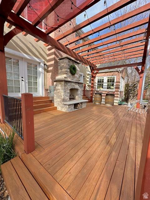 277 W Canyon Crest Rd, Alpine, UT 84004 - wooden deck with french doors, a pergola, and an outdoor stone fireplace