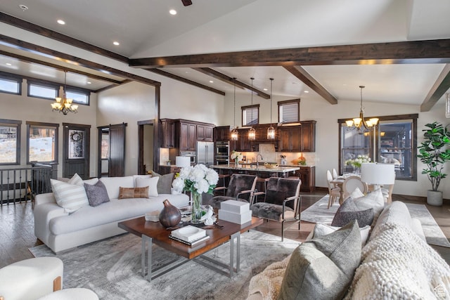 living room featuring a towering ceiling, light hardwood / wood-style flooring, beam ceiling, and a chandelier