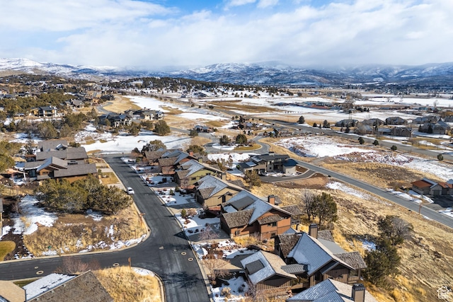 snowy aerial view with a mountain view