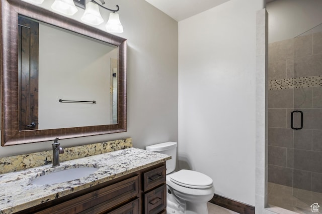 bathroom featuring toilet, walk in shower, and vanity
